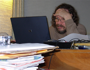 Image of Robert Schoch facing moutains of emails