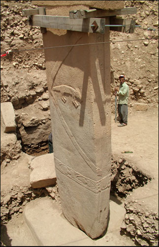 Image of central pillar of Enclosure D at Göbekli Tepe, showing anthropomorphic 
				features